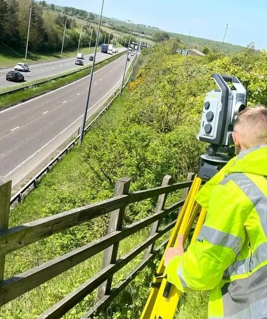 Topographical Surveyor, surveying busy road